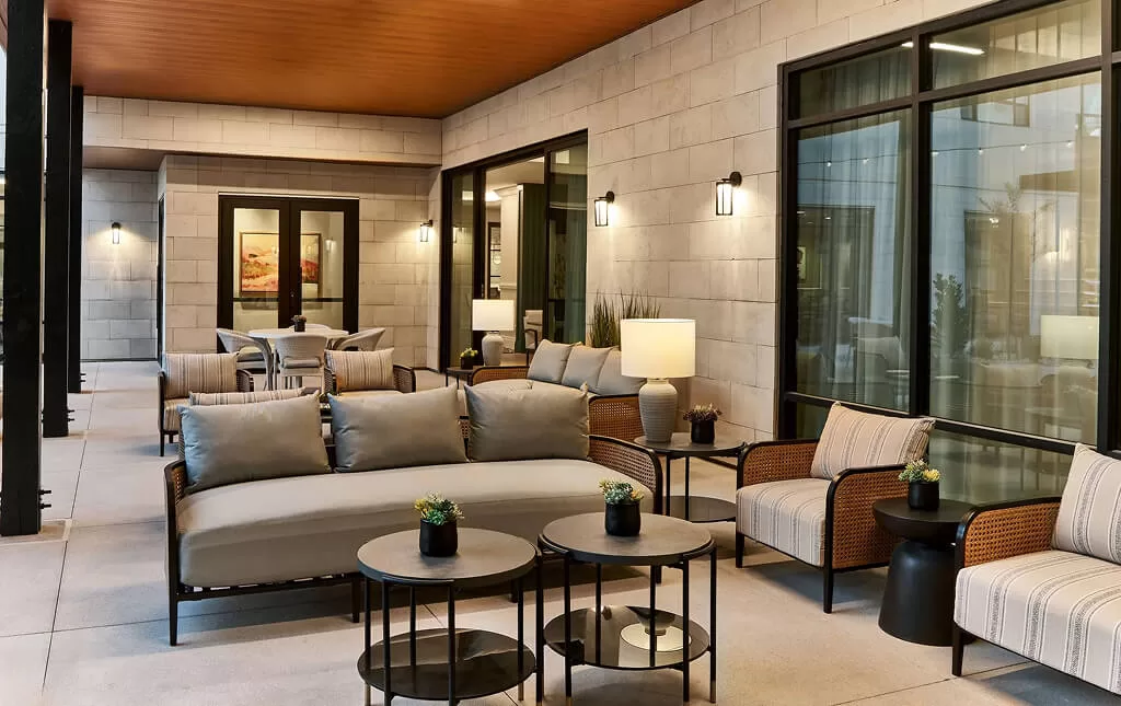 Cozy outdoor lounge with comfortable seating in a senior living community